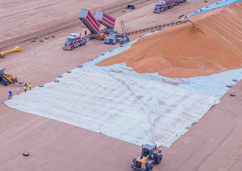 Concrete tyres weigh down a ground sheet in Merrywinebone, NSW.