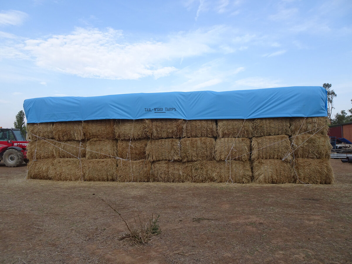 Stacked hay covered with a Tail-Wind hay cover