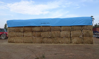 Stacked hay covered with a Tail-Wind hay cover