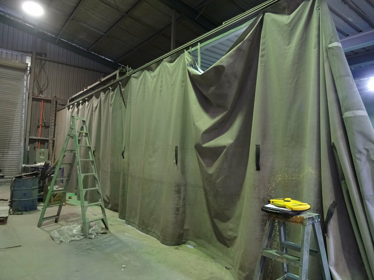 A large industrial curtain hanging up inside a warehouse