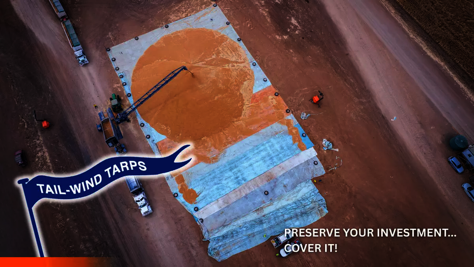 A grain bunker liner with sorghum being poured on top of it.