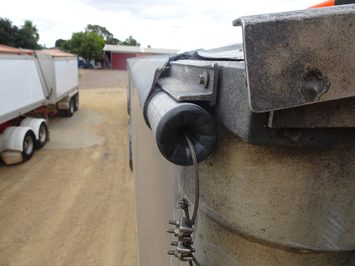 A tarp pipe with an aluminium cable running through it as part of a roll-over tarp system