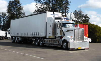 A white truck is parked at a truck stop