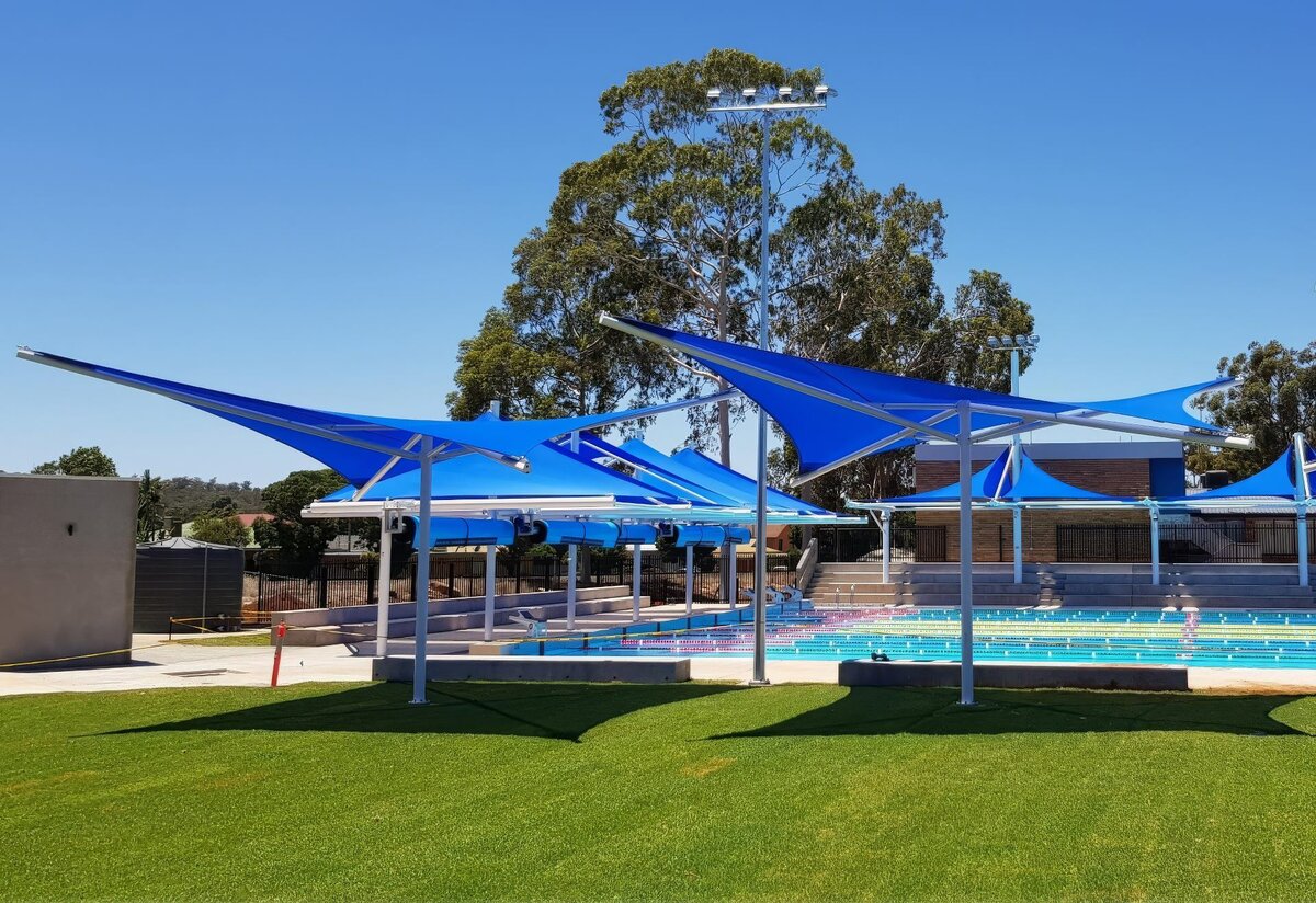 Griffith Aquatic Centre star structure shades covering a pool and lawn area.