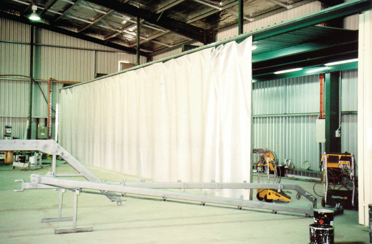 A truck curtain hanging up in a large warehouse