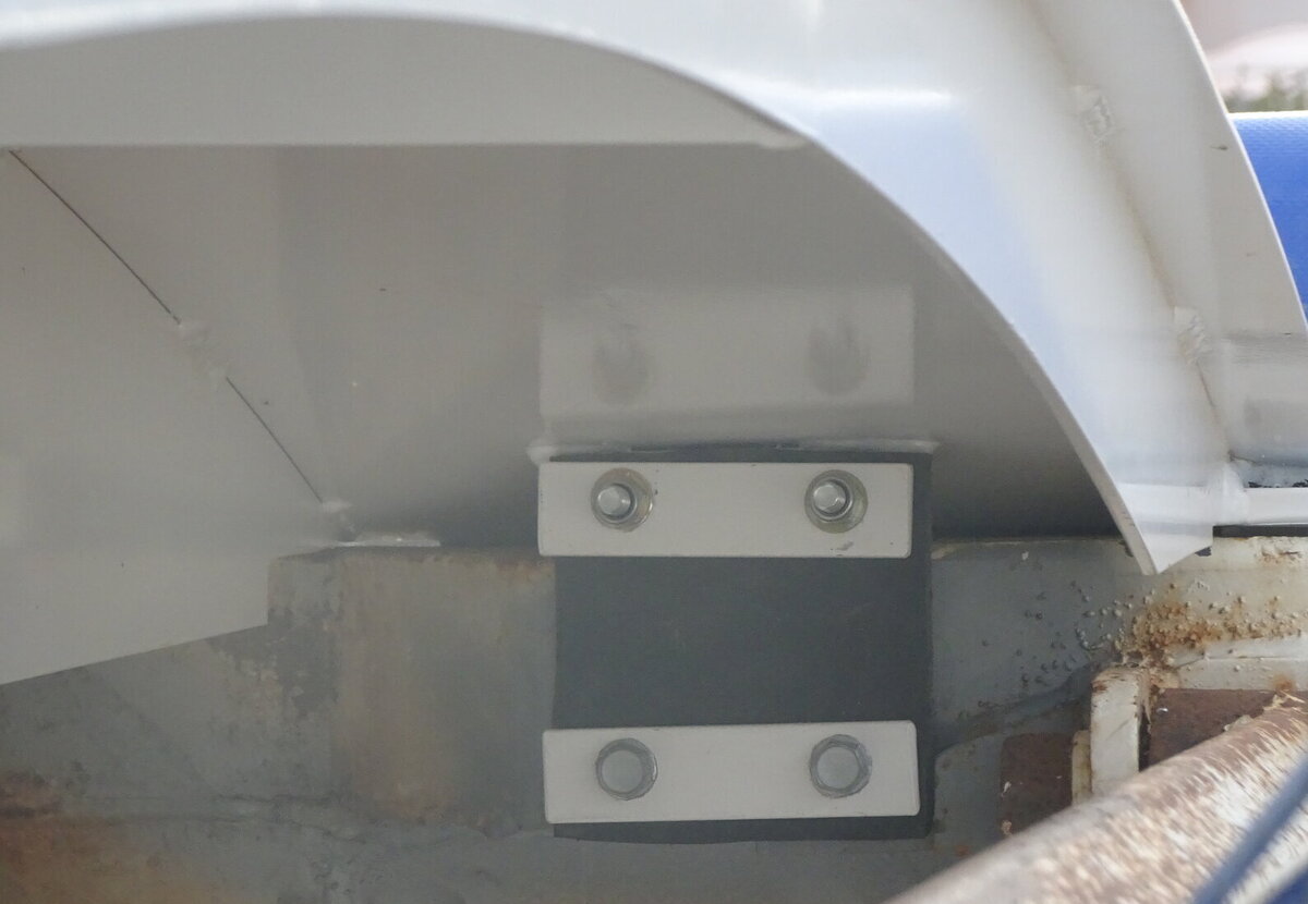 A rubber mounted fixing to a pelmet - to overcome the risk of flex cracking.