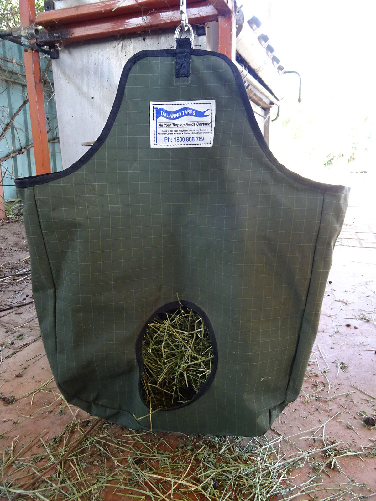 Hay bag full of hay hanging from a pole