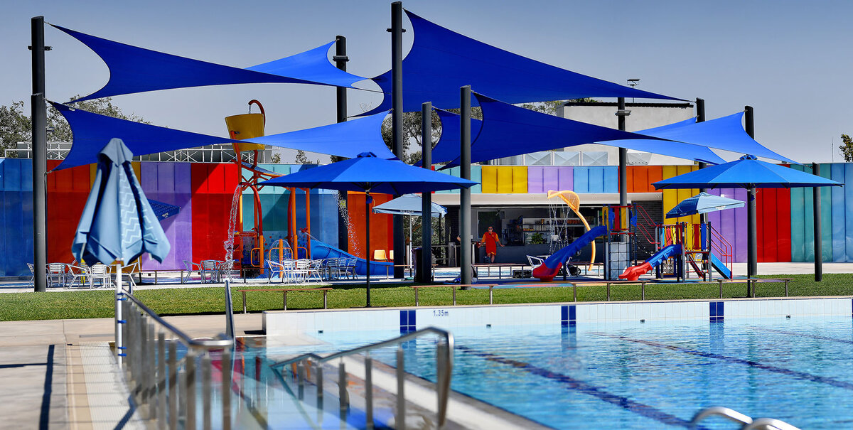 Blue shades sails covering a swimming pool