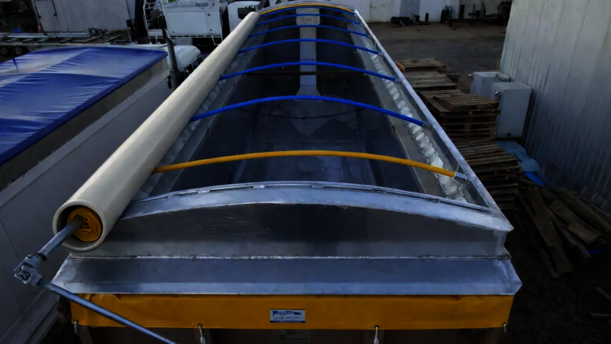 A roll-top tarp opened with PVC pipe covering the roll to protect it from the sun.