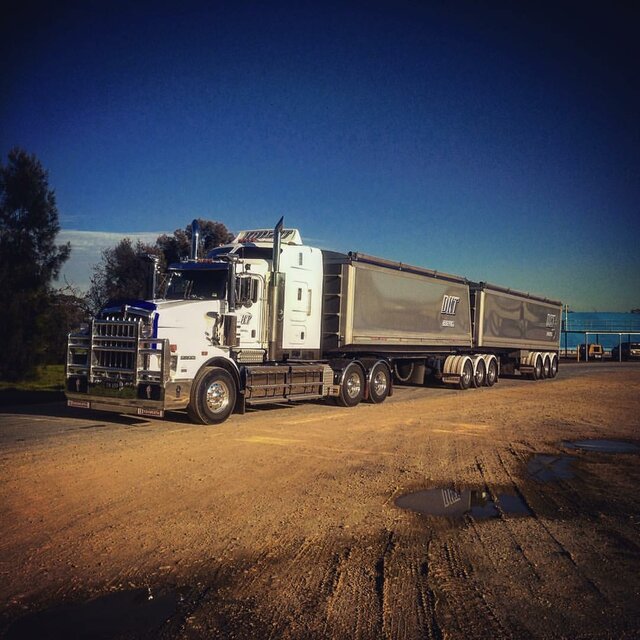 A David Knight Transport truck with semi-trailers that use Tail-Wind Tarps Roll-Top Tarps