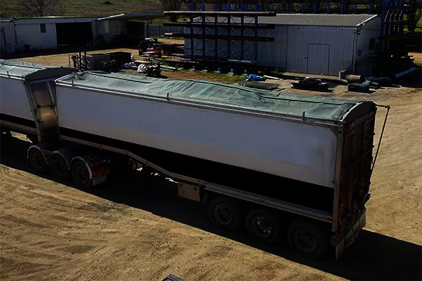 A semi-trailer loaded with too much cotton seed in the centre of the bin.