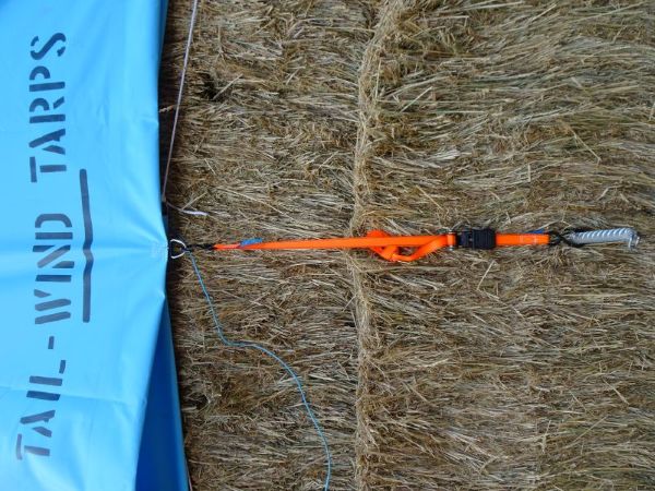 An Ellis and Sons Group Hay Cover with Pocket Hem secured firmly with a ratchet strap